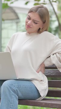 Casual Young Woman Using Laptop with Back Pain while Sitting Outdoor, Vertical Video