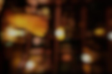 Warm bokeh lights background with golden blurry spots and dark shadows ideal for luxury branding, holiday greeting cards, and festive celebration web banners © Adrenaloby