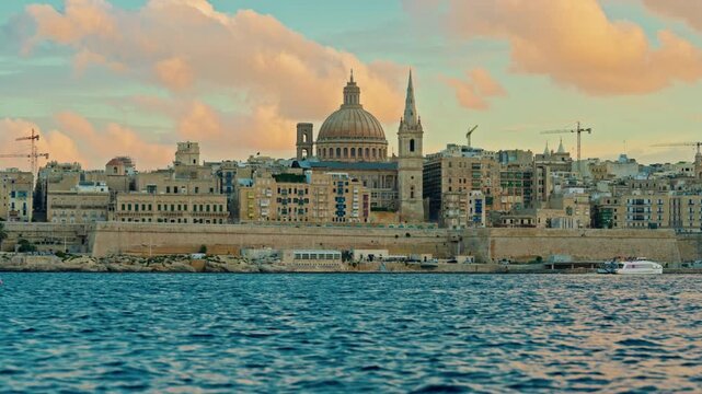 View of Valletta's of Capital City of Malta at sunny day. Marsamxett Harbour with the view on Valletta Saint Paul's Anglican Cathedral