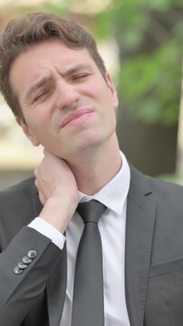 Outdoor Portrait of Businessman with Neck Pain, Vertical Video