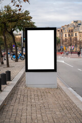 Blank vertical street billboard mockup showcasing a clean white space, ideal for advertising and marketing campaigns, positioned on a city sidewalk next to a road with blurred urban background