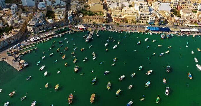 Aerial view of the Port of Marsaxlokk In Malta. A small fishing village with traditional colorful boats