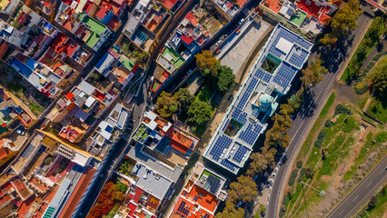 Fototapeta premium Symmetrical aerial perspective of modern building equipped with solar panels