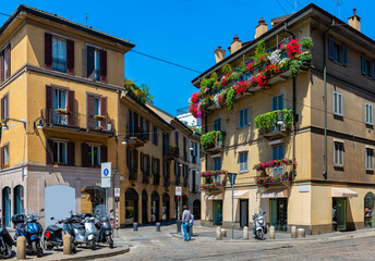 Fototapeta premium Old cozy street with flowers in Milan, Italy. Cityscape of Milan. Architecture and landmarks of Milan.
