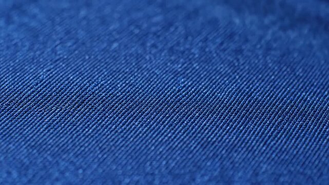 Abstract textile patterns Close-up of tightly woven fabric, shimmering under dynamic light, creating an intricate, abstract visual.