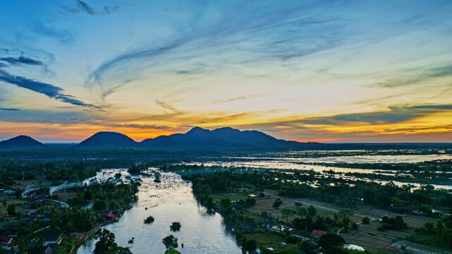 Aerial view of A Sunset Path Over the Mekong. The bridge connects a quiet island to the mainland, offering peaceful views where the smaller Mekong separates from the mighty main river.