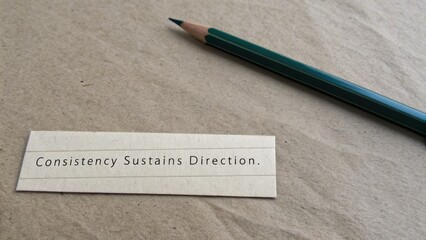 Inspirational Quote on Card with Pencil on Brown Background