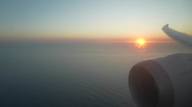 Aerial View of Boeing 787 Dreamliner Wing and Engine Flying Over Ocean at Sunrise