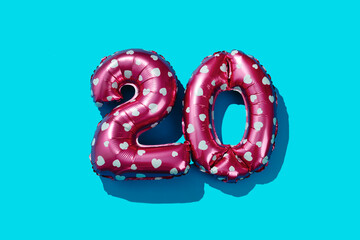 pink balloons forming the number 20 on blue