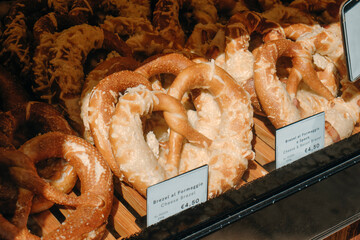 cheese pretzels displayed in a bakery window