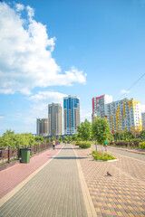 Pedestrian area with footpath in a city by sunny summer day