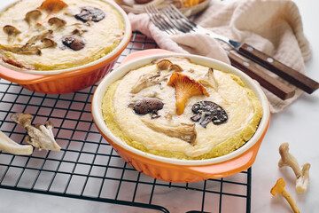 Mushroom Quiche with chanterelles, oyster mushrooms, champignons, and cheese in two backing dishes