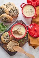 Gourmet Liver Pate Appetizer with Sesame Seed Bagels and and Fresh Pea Shoots on Rustic Wooden Board