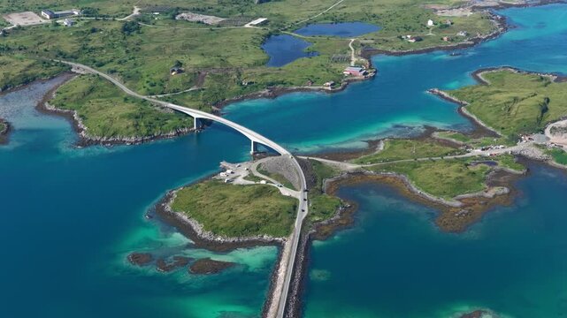 forward drone flight, top down view, Fredvang bridges, some cars on the brigde or road. Beautiful landscape seen from above, small islands, fjord, ocean. Travel theme, Beautiful Norway. Travel destina