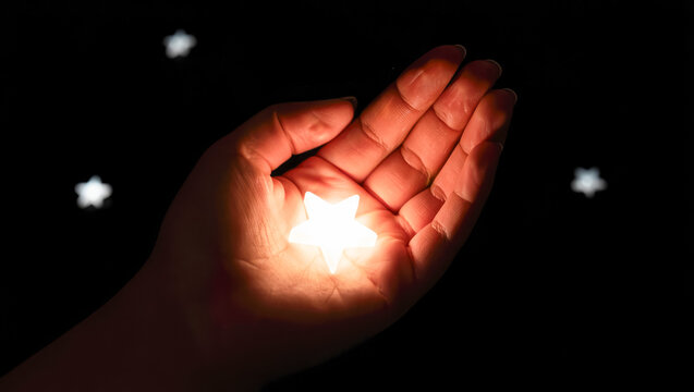 Hand holding glowing star, darkness, magical atmosphere, inspiration, hope, artistic design, background for creative projects, dreaming concept, tranquility mood, making a wish, dreams come true