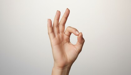 Naklejka premium Hand making okay gesture on neutral background 