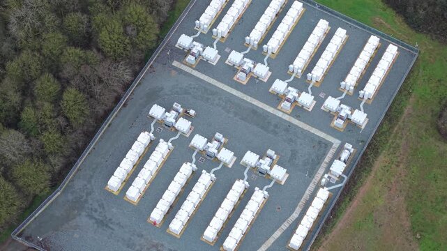 Aerial view of Battery Energy Storage Systems BESS contrasting with the adjacent greenery, a modern energy landscape, Enderby, Enderby, United Kingdom.