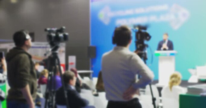 Corporate Presenter Addressing Audience at Business Conference