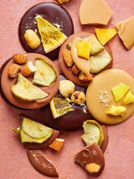 A close-up view of assorted dark, milk, and caramel chocolate disks