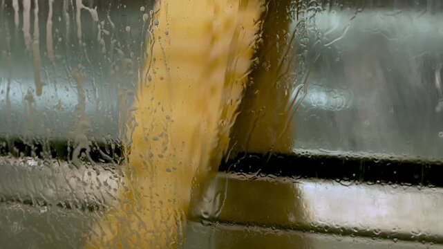Colorful textile fabrics being washed in an industrial textile factory. Fabric finishing process where dyed materials are cleaned and prepared before being used in clothing manufacturing.