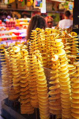 Stall selling delicious fried potatoes on skewers at a street market in Barcelona, ​​Spain