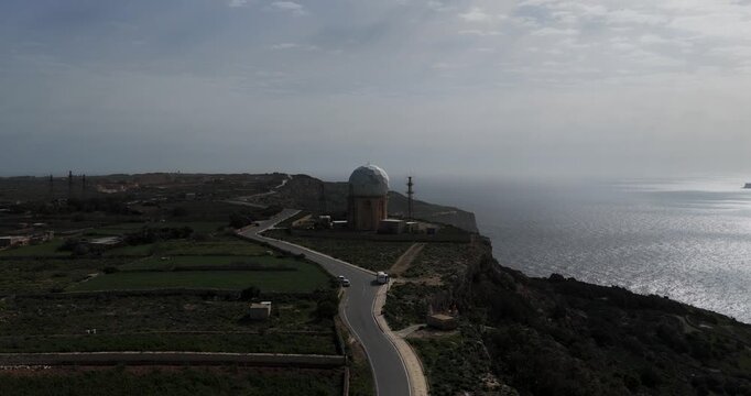 Aerial view of the Dingli Radar station and the stunning coastline, where the dark cliffs meet the vast expanse of the sea, Dingli, Dingli Radar, Malta.