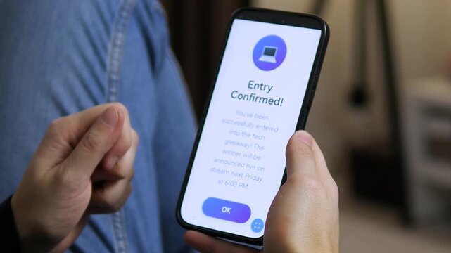 Millennial wins digital contest entry on mobile phone. Trendy shot of smartphone UI showing successful registration. Ideal for vlogs, tech reviews, and e-commerce ads. Authentic emotion and modern