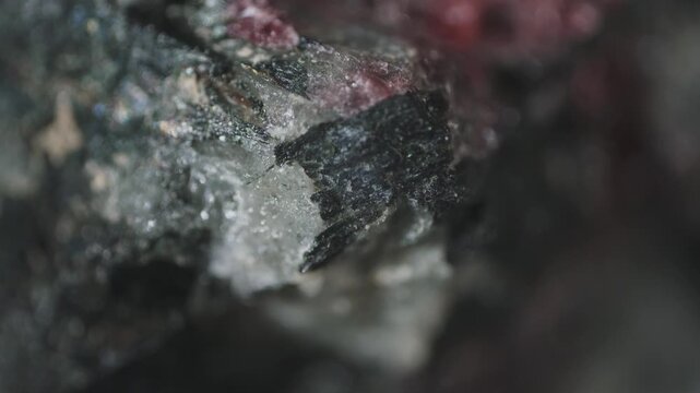 Macro image of weathered aegirine, natrolite and eudialyte crystals captured via microscope objective at 2.4&times; magnification with 15 mm field of view. Surface alteration and fragmentation
