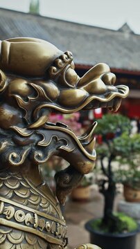 Chengdu, Sichuan, China. Bronze Lion Head Sculpture. Statue Of Mystical Chinese Guardian Lion. Head Of Golden Lion Statue At Wenshu Monastery. Sculptures Of Kylins Or Qilin. Kylins Is Mascot Dragon In