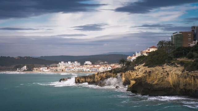 Waves crashing against cliffs in Altafulla on a cloudy day, Catalonia