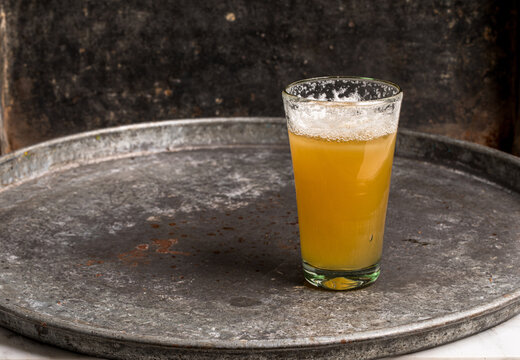 Light beer in glass on metal tray