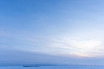 A tranquil seascape captures a sunrise over a frozen sea
