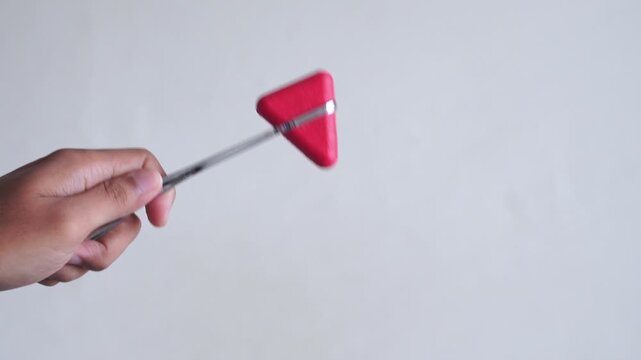 Close-up of reflex hammer on white background