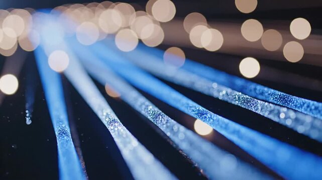 Fiber optic cables with glowing ends and bokeh light streaks