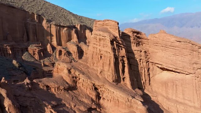 Aerial view of aeolian castle eroded geological formations in Kyrgyzstan - Konorchek canyons. Arc camera movment with parallax effect.