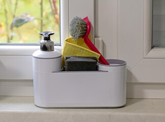 Tools for cleaning dishes in box inside kitchen interior