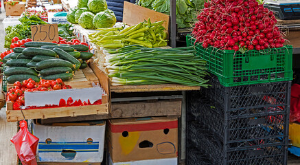 Fresh organic raw vegetables outside on a market stall