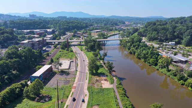 Aerial view of Asheville city in North Carolina with high buildings and Appalachian mountain hills
