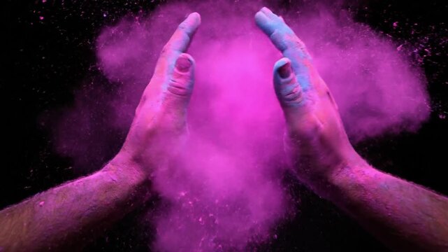 hands covered in pink powder on black background for vibrant creative concept with artistic expression and colorful design elements