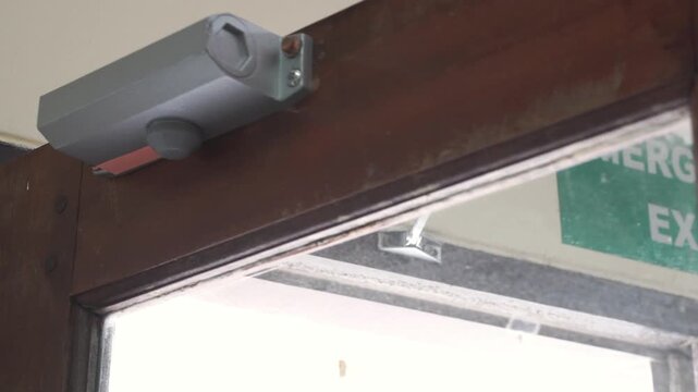 Automatic Door Closer on Wooden Door.