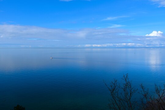 View of the Adriatic sea with white couds on blue sky