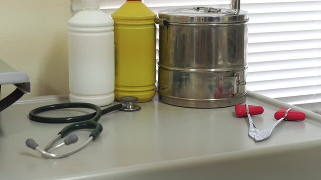 Doctor checking patient's blood pressure with a sphygmomanometer and stethoscope, close-up of arm and medical equipment