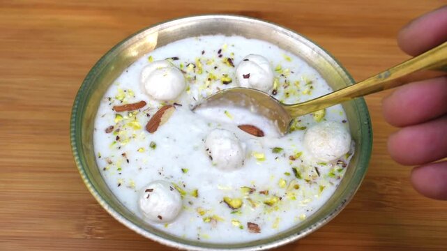 Traditional Indian dessert makhana kheer served in a copper bowl with spoon.
