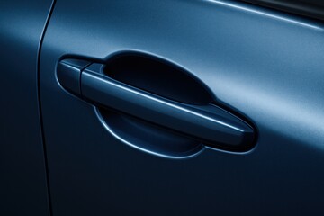 Close-up of a modern car door handle in a cool blue tone. Great for automotive themes, design projects, or anything related to cars and modern transportation.