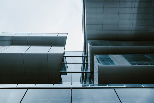 Minimal steel and glass architecture with strong overhang and precise structural lines creating modern geometric order for abstract background