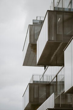 Stacked balconies and concrete modules forming a modern geometric facade pattern creating abstract urban residential background texture
