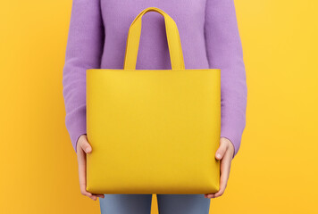 a woman holding a yellow bag