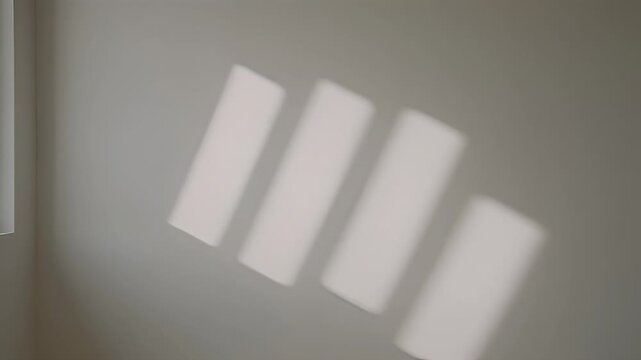 Abstract architectural interior with neutral wall and diffused window light patterns