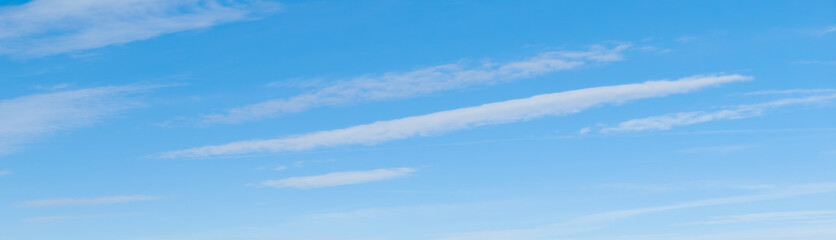 White cirrus clouds in the blue sky
