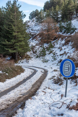 Snow Chain Mandatory Road Sign on Snowy Mountain Road in Sardinia